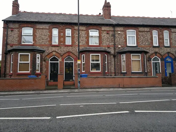 Victorian red-brick terraced houses with bay windows on Manchester Road, Altrincham