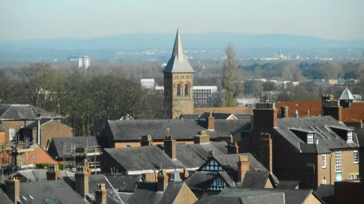 Slate rooftops and chimneys of Altrincham with the spire of St George's Church