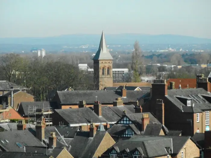 Slate rooftops and chimneys of Altrincham with the spire of St George's Church