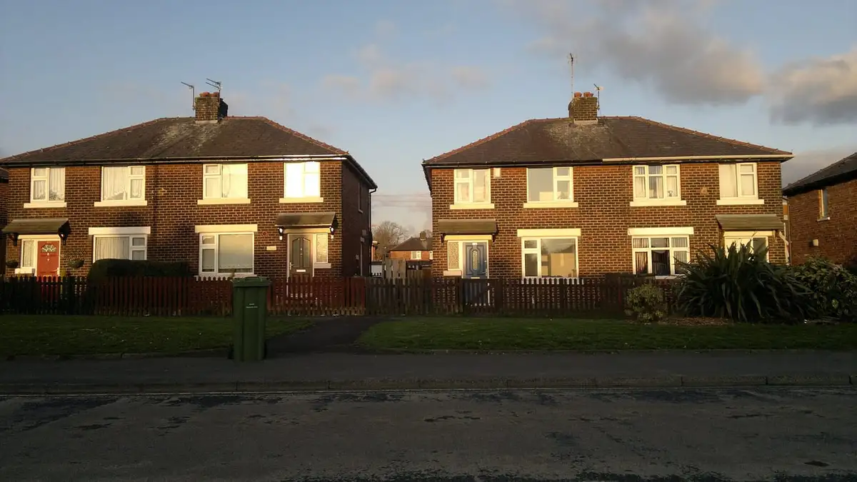Pairs of semi-detached houses on Queens Road, Ashton-under-Lyne, in evening light