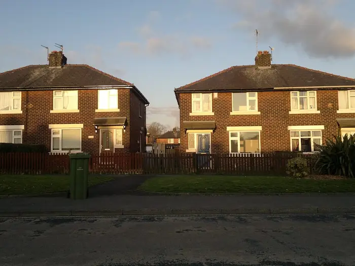 Pairs of semi-detached houses on Queens Road, Ashton-under-Lyne, in evening light