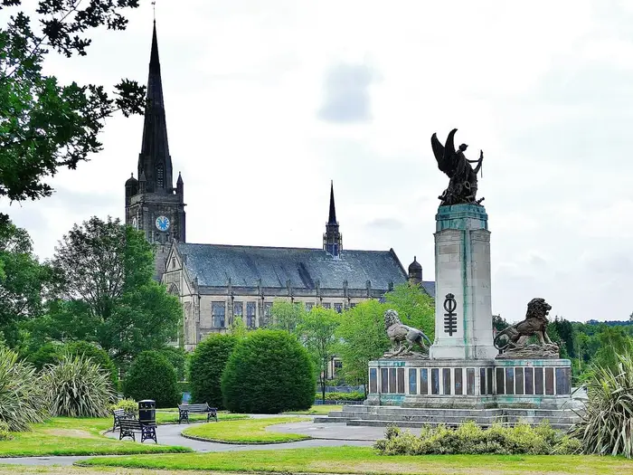 Ashton-under-Lyne war memorial and Albion Church spire in the Memorial Gardens