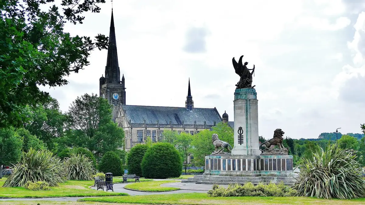 Ashton-under-Lyne war memorial and Albion Church spire in the Memorial Gardens
