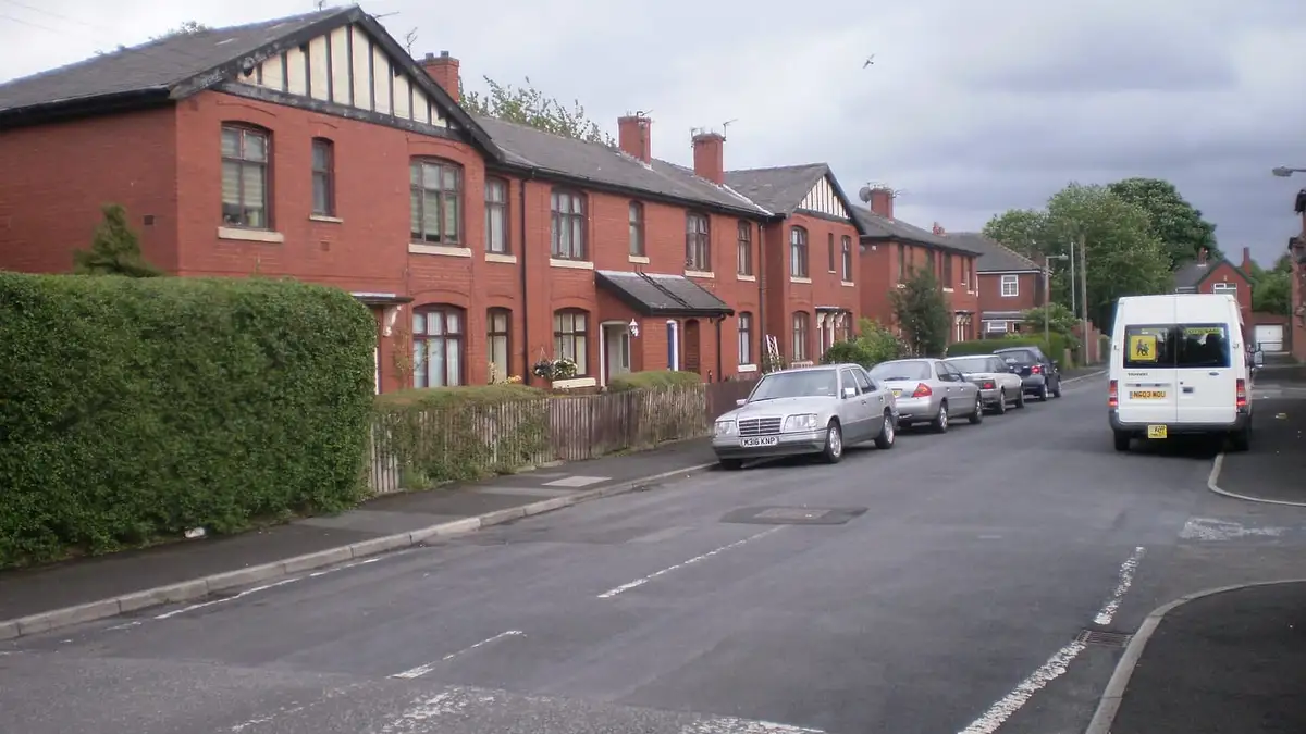 Red-brick terraced houses with slate roofs on Carlton Street, Bury