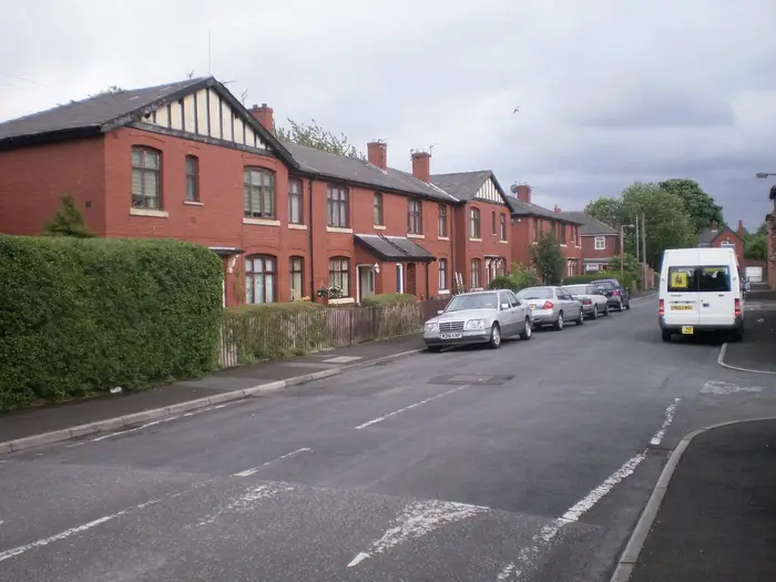 Red-brick terraced houses with slate roofs on Carlton Street, Bury