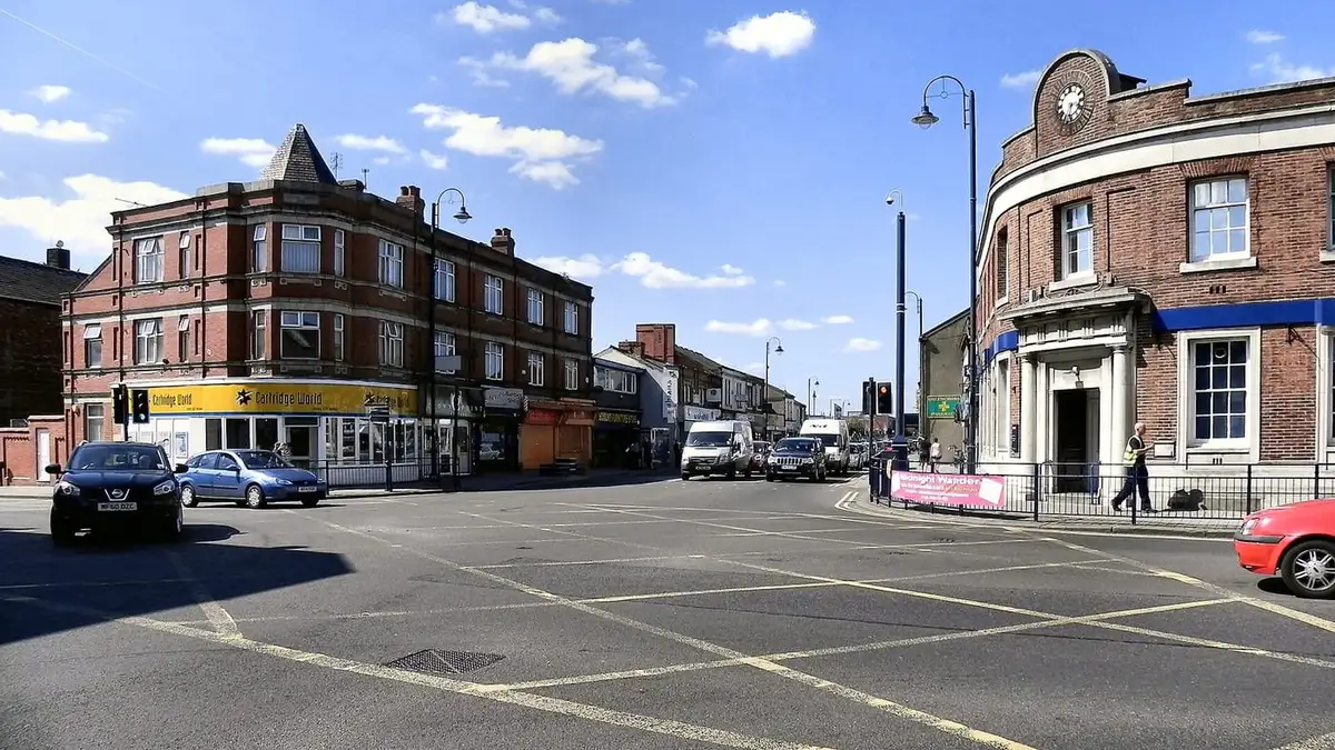 Crown Point junction in Denton town centre with its brick bank and shops