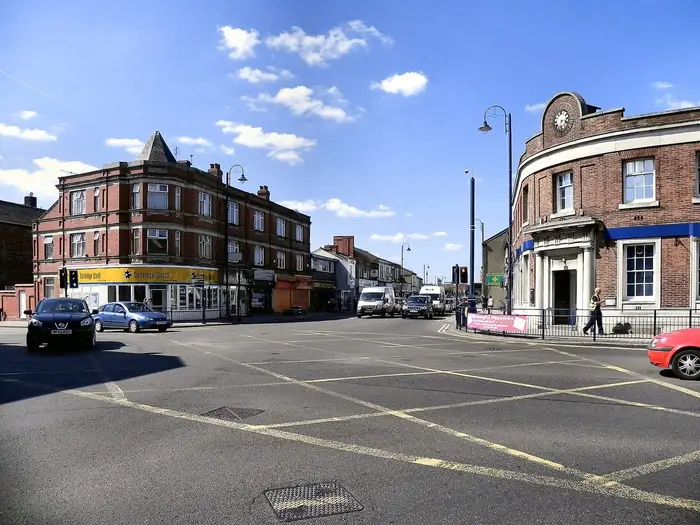 Crown Point junction in Denton town centre with its brick bank and shops