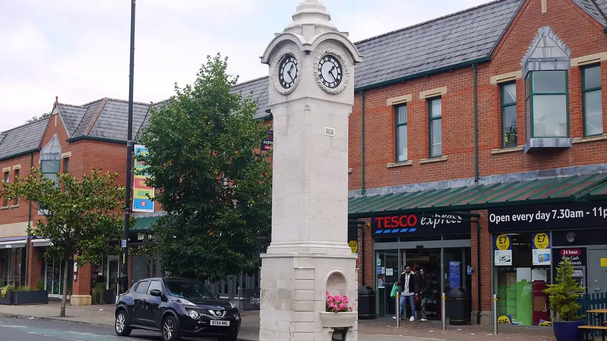 Rhodes Memorial Clock Tower and shops on Wilmslow Road, Didsbury village