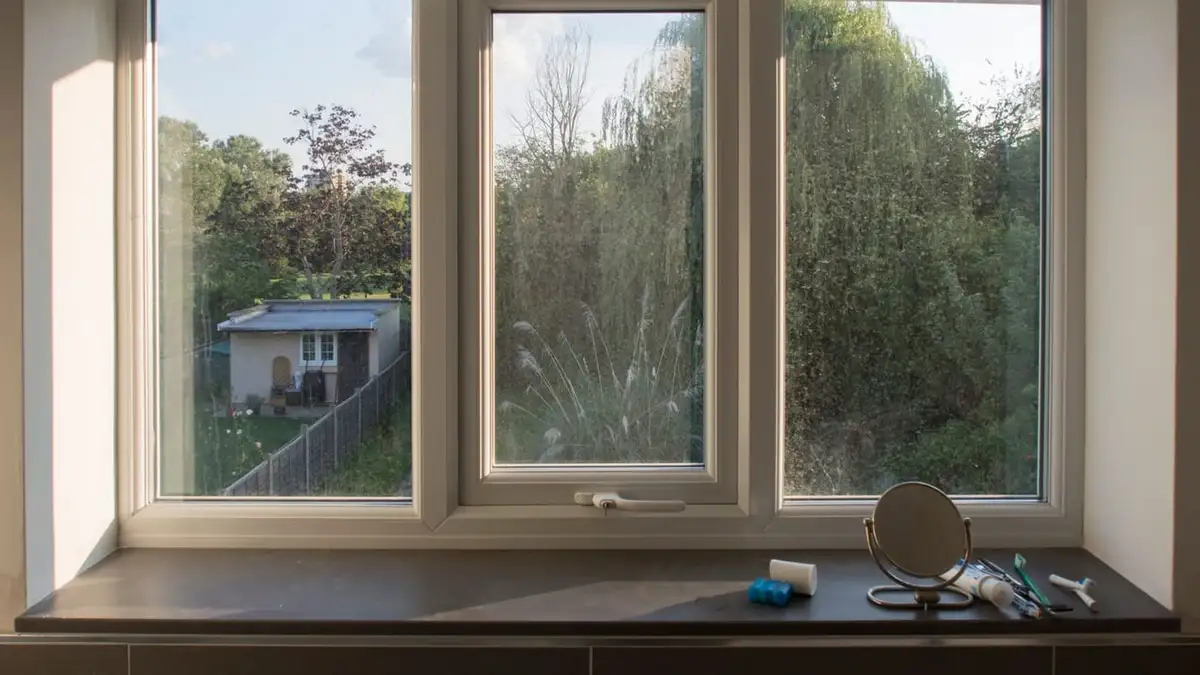 White uPVC double-glazed triple window looking out onto a garden