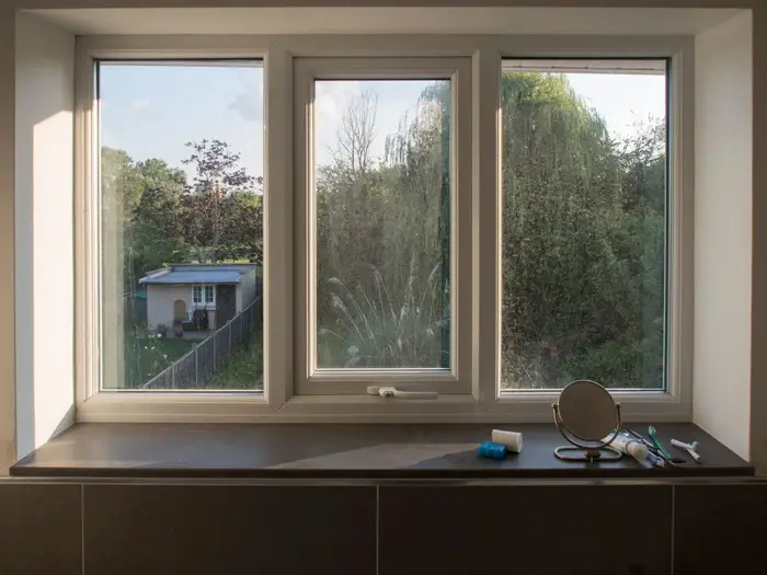 White uPVC double-glazed triple window looking out onto a garden