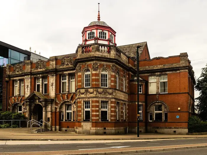 Ornate red-brick and terracotta building with a cupola in Eccles town centre