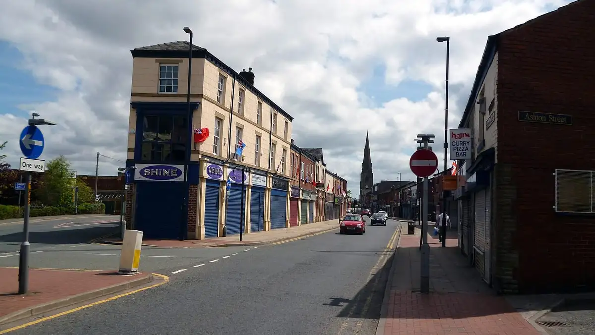 Bridge Street in Heywood town centre with a church spire in the distance
