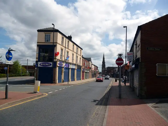 Bridge Street in Heywood town centre with a church spire in the distance