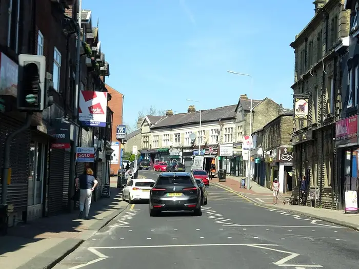 Shops and stone buildings along Lee Lane, the main street in Horwich