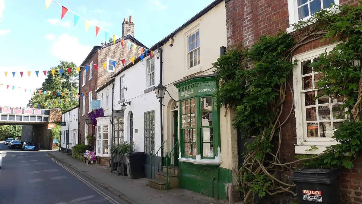 Historic brick and painted shops along King Street, Knutsford, with bunting