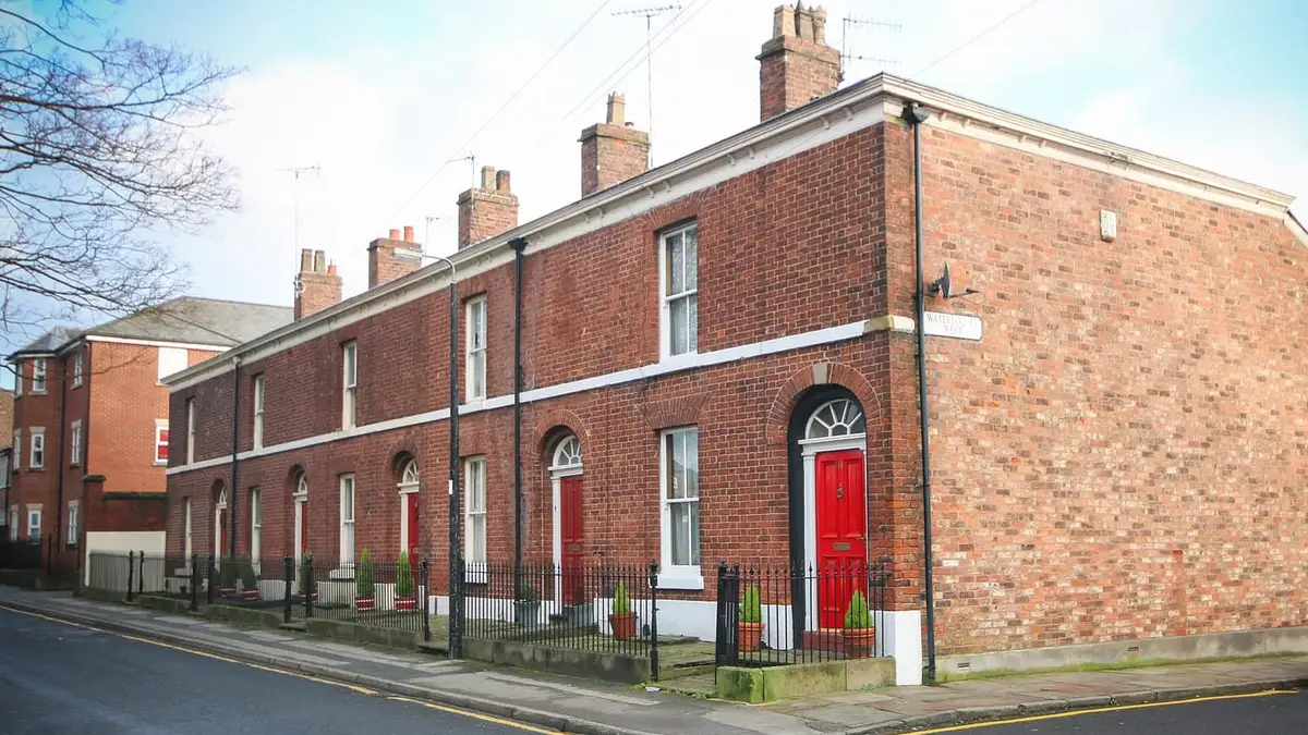 Georgian brick terraced houses with red doors on Waterloo Street West, Macclesfield