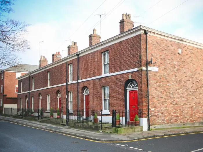 Georgian brick terraced houses with red doors on Waterloo Street West, Macclesfield