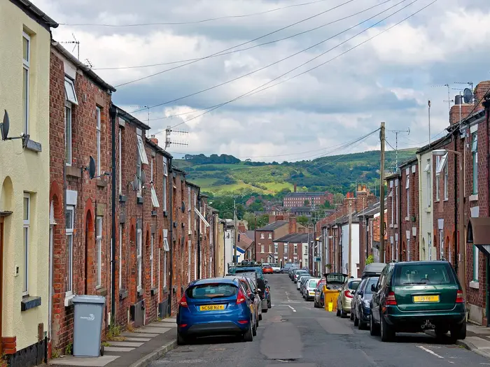 Terraced rooftops on Barton Street, Macclesfield, with hills beyond