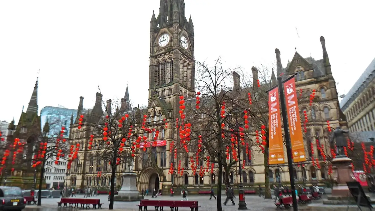Manchester Town Hall's Gothic clock tower seen across Albert Square, city centre