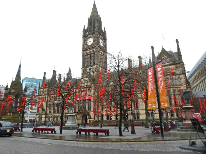 Manchester Town Hall's Gothic clock tower seen across Albert Square, city centre