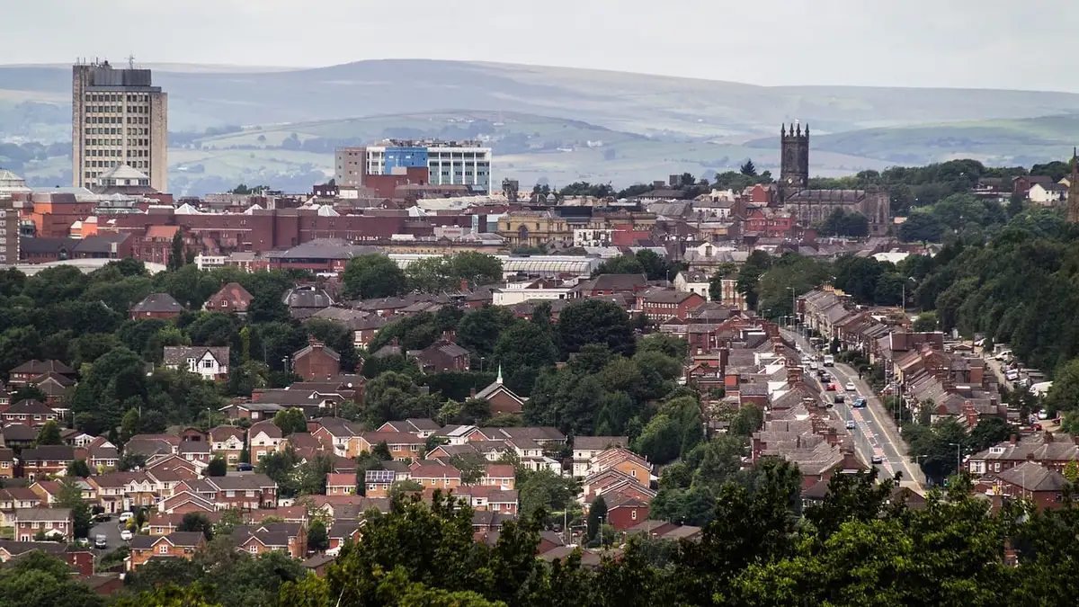 Rooftops of Oldham with the parish church and Pennine hills behind
