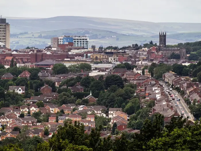 Rooftops of Oldham with the parish church and Pennine hills behind