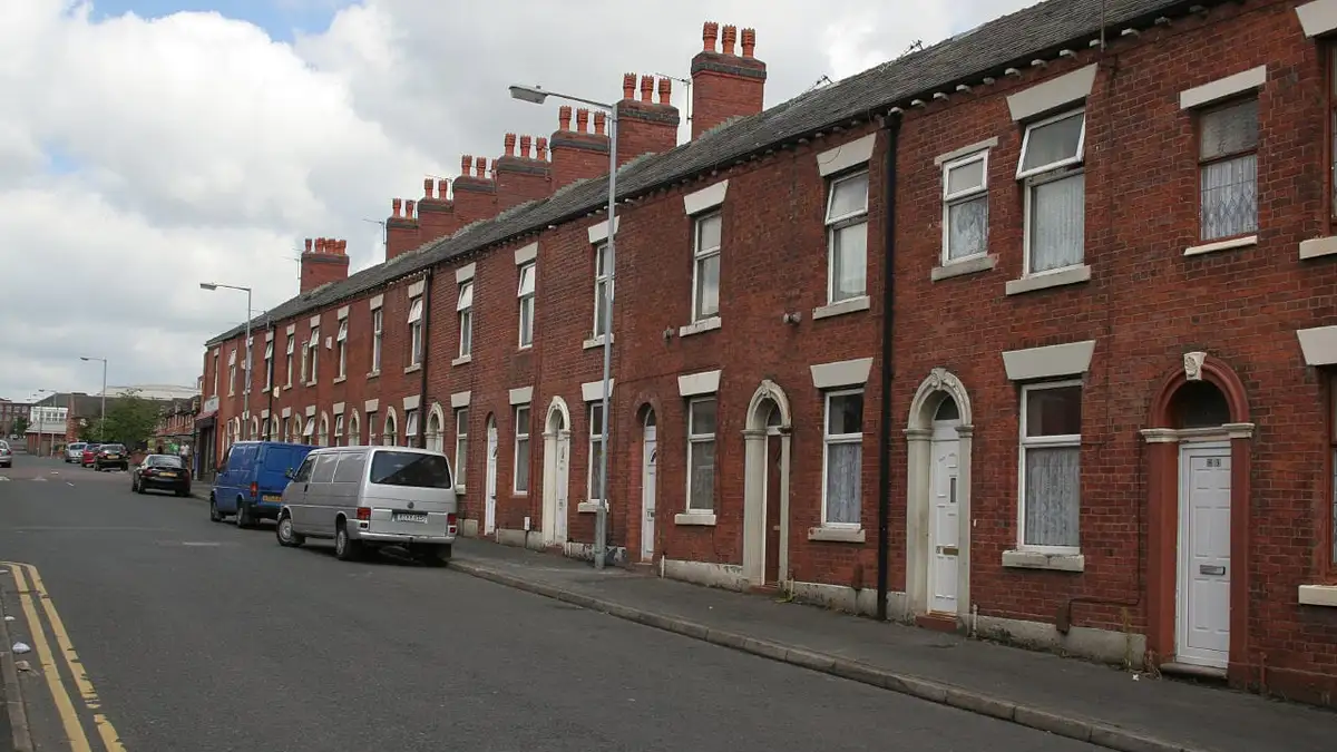 Row of red-brick terraced houses on Main Road, Oldham