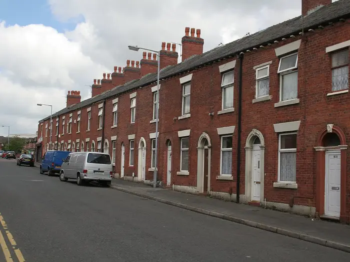Row of red-brick terraced houses on Main Road, Oldham