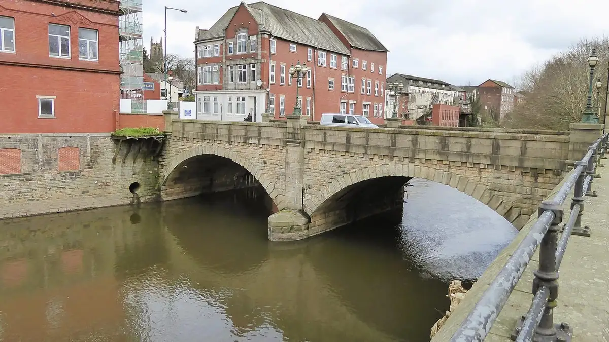 Stone arched Radcliffe Bridge over the River Irwell, Radcliffe