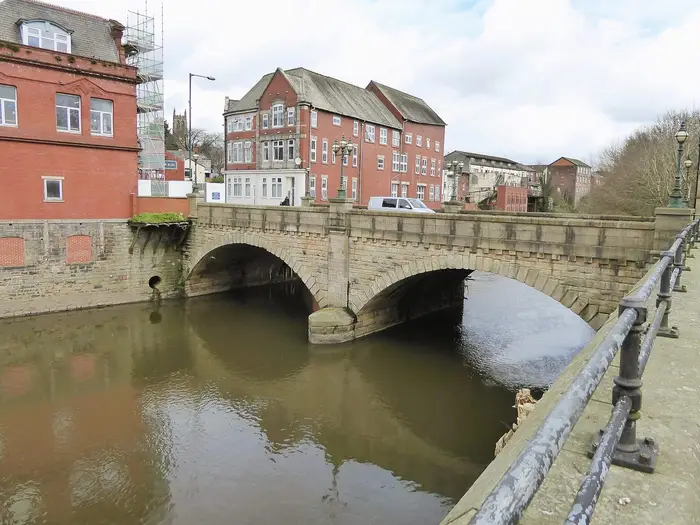 Stone arched Radcliffe Bridge over the River Irwell, Radcliffe