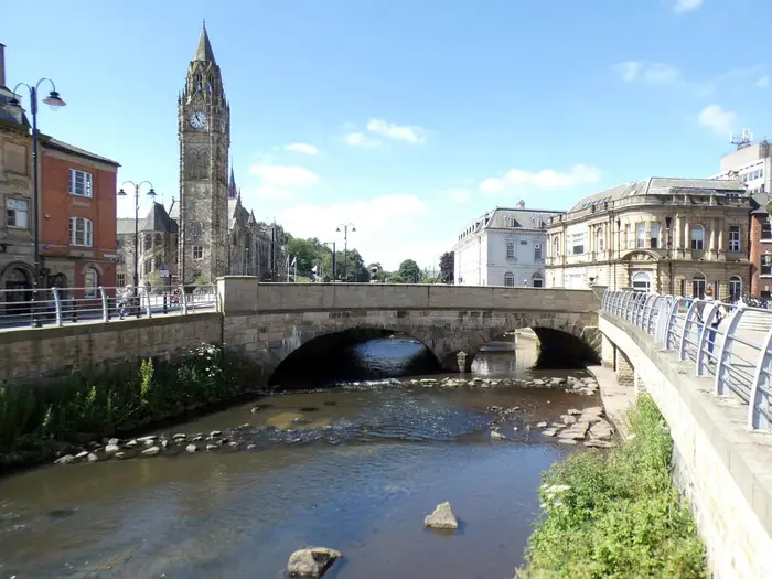The uncovered River Roch flowing past Rochdale Town Hall in the town centre