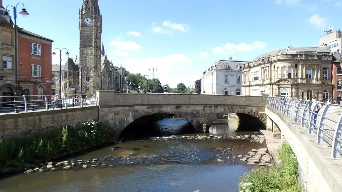 The uncovered River Roch flowing past Rochdale Town Hall in the town centre