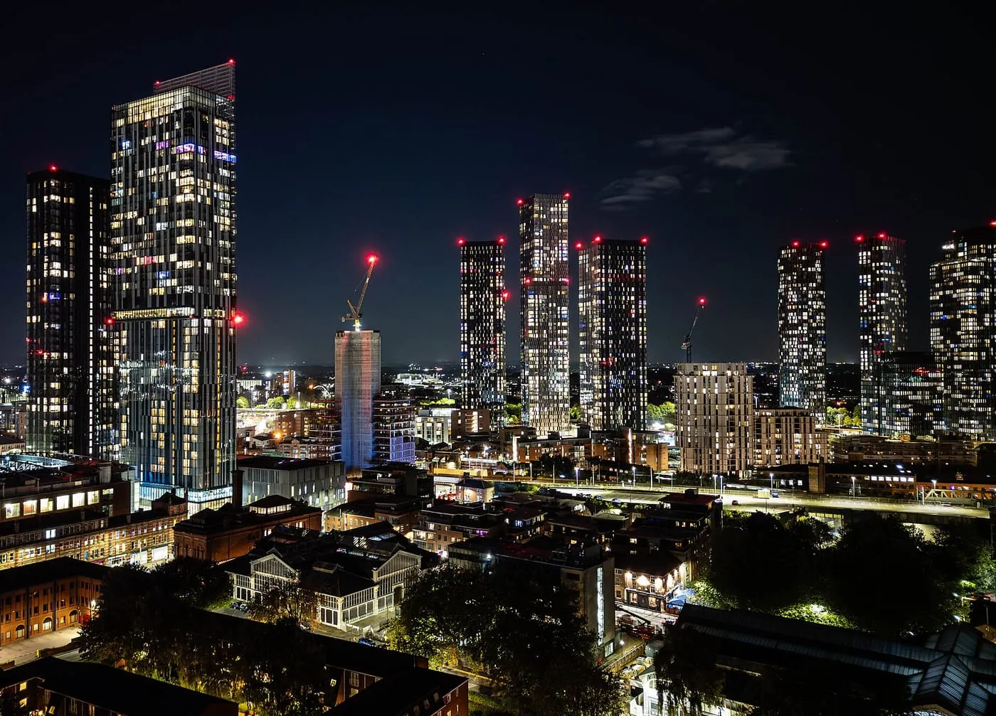 Manchester city centre skyline at night with lit tower blocks