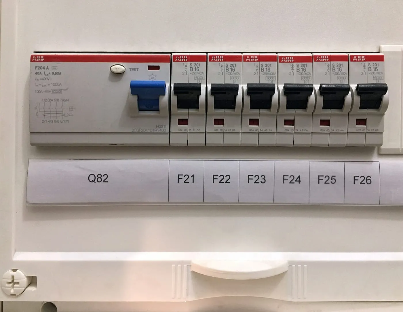 RCD trip switch beside a row of circuit breakers in a consumer unit