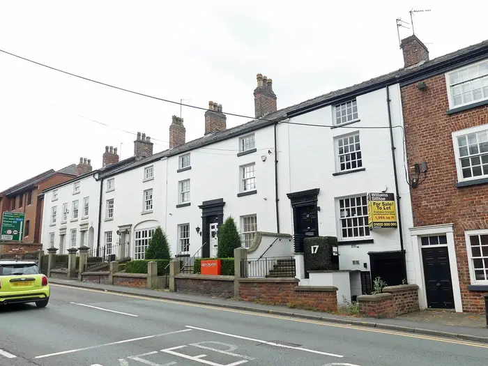 Grade II listed whitewashed terraced cottages on Manchester Road, Wilmslow
