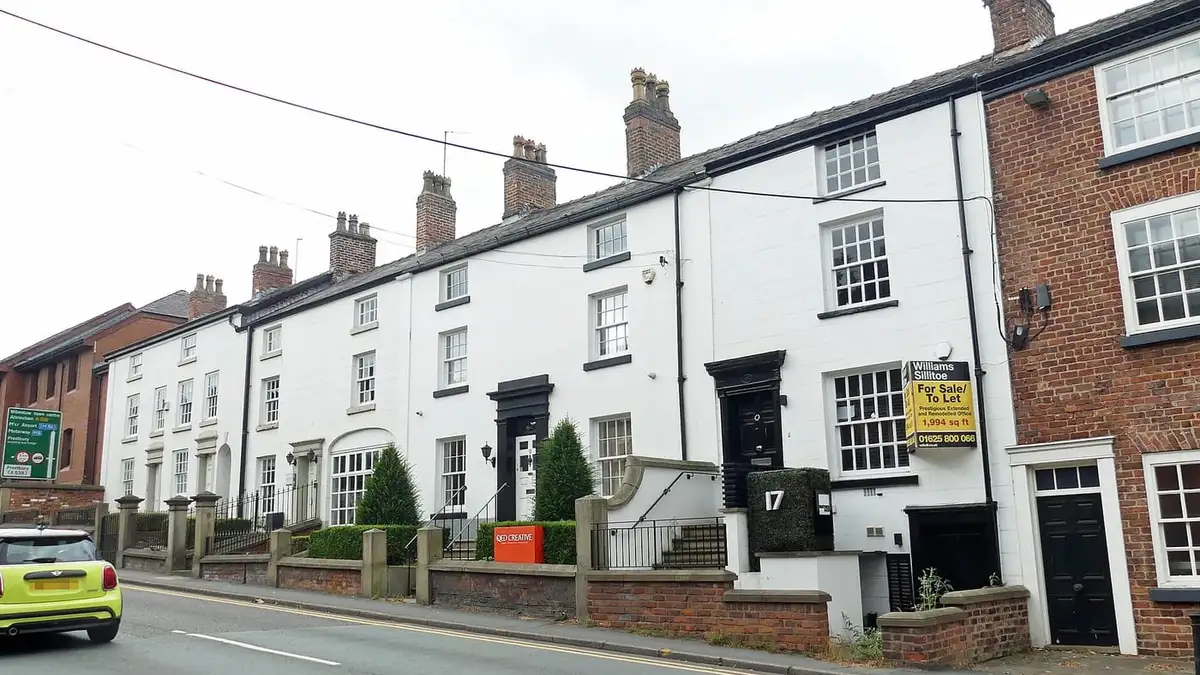 Grade II listed whitewashed terraced cottages on Manchester Road, Wilmslow