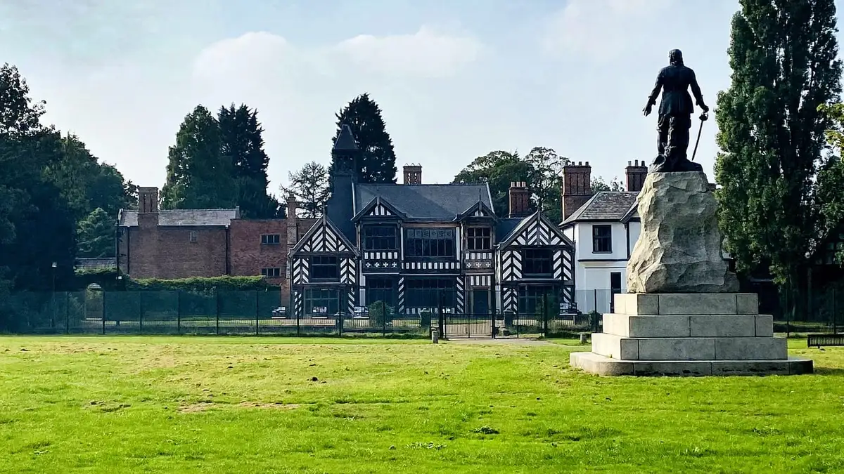 Timber-framed Wythenshawe Hall and the Cromwell statue in Wythenshawe Park