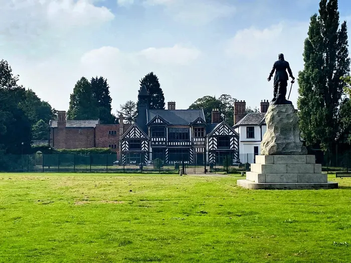 Timber-framed Wythenshawe Hall and the Cromwell statue in Wythenshawe Park